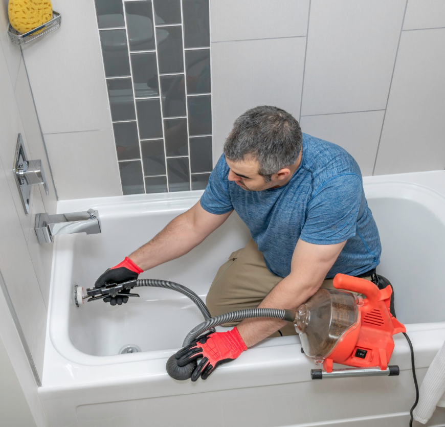 Plumber servicing a drain